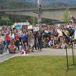 Christina Love leads the audience in raising their fist, symbolizing telling the truth despite fear on Saturday, June 14, 2025. (Natalie Buttner / Juneau Empire)