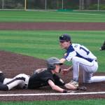Juneaus Auke Bay Post 25 shortstop Kasen Ludeman attempts to tag Anchorages South Post 4 runner Mark Warren at third base during Alaska American Legion baseball action Saturday at Adair-Kennedy Memorial Park. (Klas Stolpe / Juneau Empire)