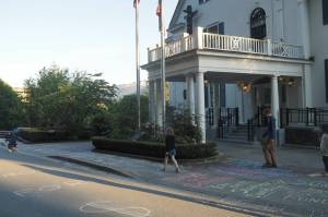 Families write messages in chalk outside the governor's mansion on Friday, June 13, 2025. (Natalie Buttner / Juneau Empire)