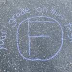 Chalk message written outside the governor's mansion reading, 'your grade on this test F'. Written on Friday, June 13, 2025. (Natalie Buttner / Juneau Empire)