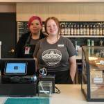 Sacred Ground baristas Raven Salduvar and Mackenzie Gray serve coffee in their new location, Aan Hít, on Sunday, June 22, 2025. (Jasz Garrett / Juneau Empire)