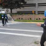 Maeve Wolf cheers for her fellow Blue Men, Trevor Daniels and Kaylee Brown as they race towards the finish on Friday, June 20, 2025. (Natalie Buttner / Juneau Empire)