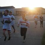 Members of the decagon of bowling pins run in the late night sun on Friday, June 20, 2025. On the right is Neve McNamara, the bowling ball. (Natalie Buttner / Juneau Empire)