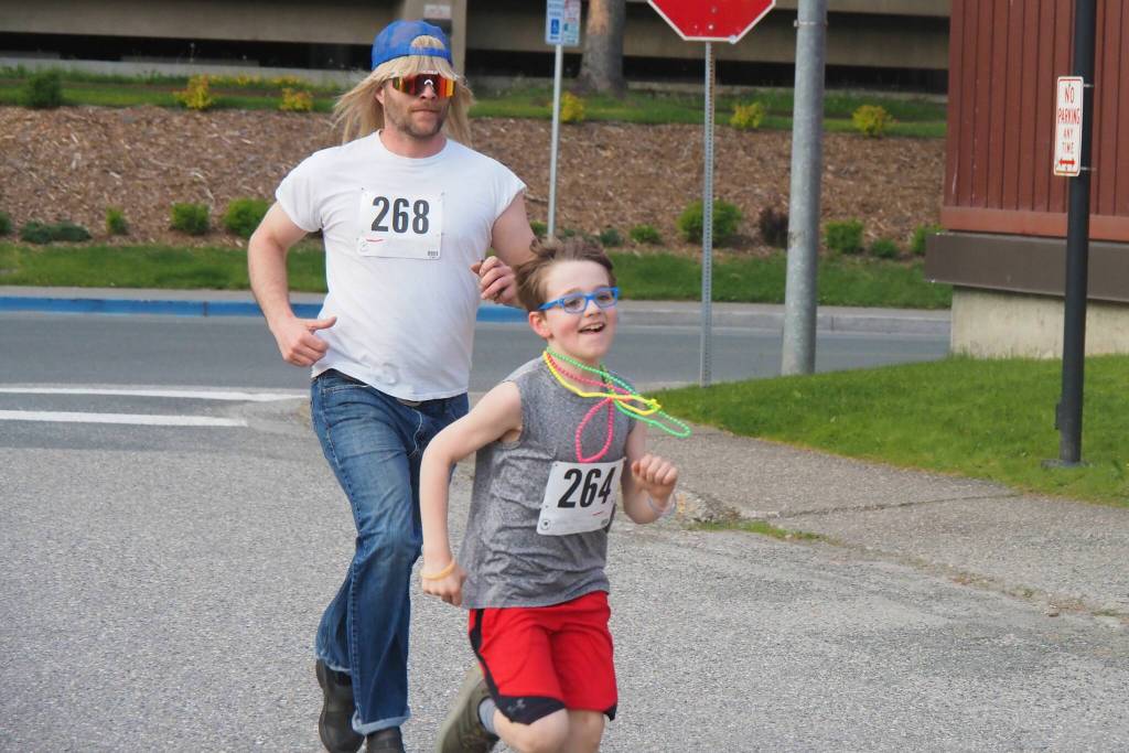 Richard (right) and Doryn Goudie make a mad dash for the finish on Friday, June 20, 2025. (Natalie Buttner / Juneau Empire)