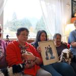 Faith Rogers loved ones, from left to right, James Rogers (father), Michelle Rogers (sister), Harmony Wentz (daughter), Maria Rogers (mother) and Mindy Voigt (friend) sit with Faiths three dogs in their family home. (Clarise Larson / Juneau Empire file photo)