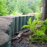 Phase One of the HESCO barriers ended in the backyard of a residence on Rivercourt Way on Monday, May 12. The extension, Phase One A, interconnected the barriers through a gap in the back fence along the river adjacent to Dimond Park from the end of Rivercourt Way. (Jasz Garrett / Juneau Empire)