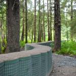 HESCO barriers wind through the forest near Thunder Mountain Middle School on Thursday, June 26<ins>,</ins> <ins>2025</ins>. (Jasz Garrett / Juneau Empire)