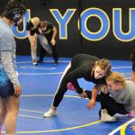 2024 Olympic wrestling gold medalist Amit Elor, 21, center, demonstrates a 2-on-1 counter move on Petersburgs Mitkof Middle Schools Freya Fenner, 13, as Palmers Colony High School 2025 Alaska state champion Amelia Fawcett, 18, looks on during the Juneau Girls Wrestling Clinic on Tuesday at the Juneau Wrestling Center. (Klas Stolpe / Juneau Empire)
