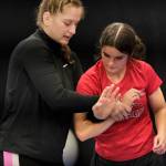 2024 Olympic wrestling gold medalist Amit Elor, 21, demonstrates a counter grip on Wasilla High School sophomore Ruby Thomas, 16, during the Juneau Girls Wrestling Clinic on Tuesday at the Juneau Wrestling Center. (Klas Stolpe / Juneau Empire)