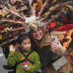 Members of Juneau Ati-Atihan pause to take a photo during the 2025 downtown Juneau Fourth of July parade. (Natalie Buttner / Juneau Empire)