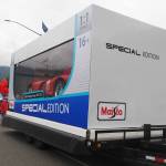 The Affordable Auto Sales float, a one-to-one replica of a Maisto remote-control car box with a real car inside impresses crowds as it travels down Egan Drive during the 2025 downtown Juneau Fourth of July parade. (Natalie Buttner / Juneau Empire)