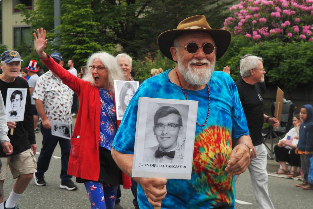 John Lancaster holds up his high school portrait as part of the Juneau-Douglas High School: Yadaa.at Kalé Class of 1970, which is celebrating its 55-year reunion on Friday, July 4, 2025. (Natalie Buttner / Juneau Empire)