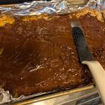 A chocolate spread makes up the second layer of this cookie bar.