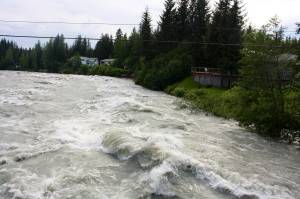 The Mendenhall River roars more than 13 feet above normal levels in August 2023. (Mark Sabbatini / Juneau Empire)