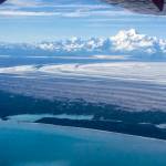 The 18,008-foot Mount St. Elias rises above Malaspina Glacier and Sitkagi Lagoon (water body center left) in 2021. (Photo by Martin Truffer)