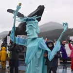 Three protesters operate a Statue of Liberty puppet at the No Tsars, No Kings on Saturday, Oct. 18. (Mari Kanagy/Juneau Empire)