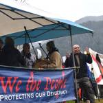 Xeetli.éesh Lyle James leads his family in a drumming and song performance at the No Tsars, No Kings protest on Saturday, Oct. 18. (Mari Kanagy/Juneau Empire)