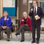 Juneau state Sen. Jesse Kiehl, standing, addresses a town hall audience Jan. 11 at Dzantik’i Heeni Middle School as Juneau state Reps. Sarah Hannan, far left, and Andi Story wait their turn to discuss their priorities during the 2023 legislative session.(Mark Sabbatini / Juneau Empire file file)