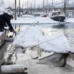 Salvage captain Trevin Carlile, left, and diver Phil Sellick at Melinos Marine Service re-float a sunken boat in Harris harbor on Jan. 8, 2026. Record-breaking snow at the beginning of the month caused at least ten boats to sink in Harris, Douglas and Aurora harbors, resulting in oil spills. (Chloe Anderson for the Juneau Empire)