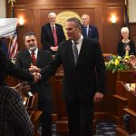 Governor Dunleavy shakes hands with a representative as he exits from his final State of the State address on Thurday, Jan. 22. (Mari Kanagy/Juneau Empire)