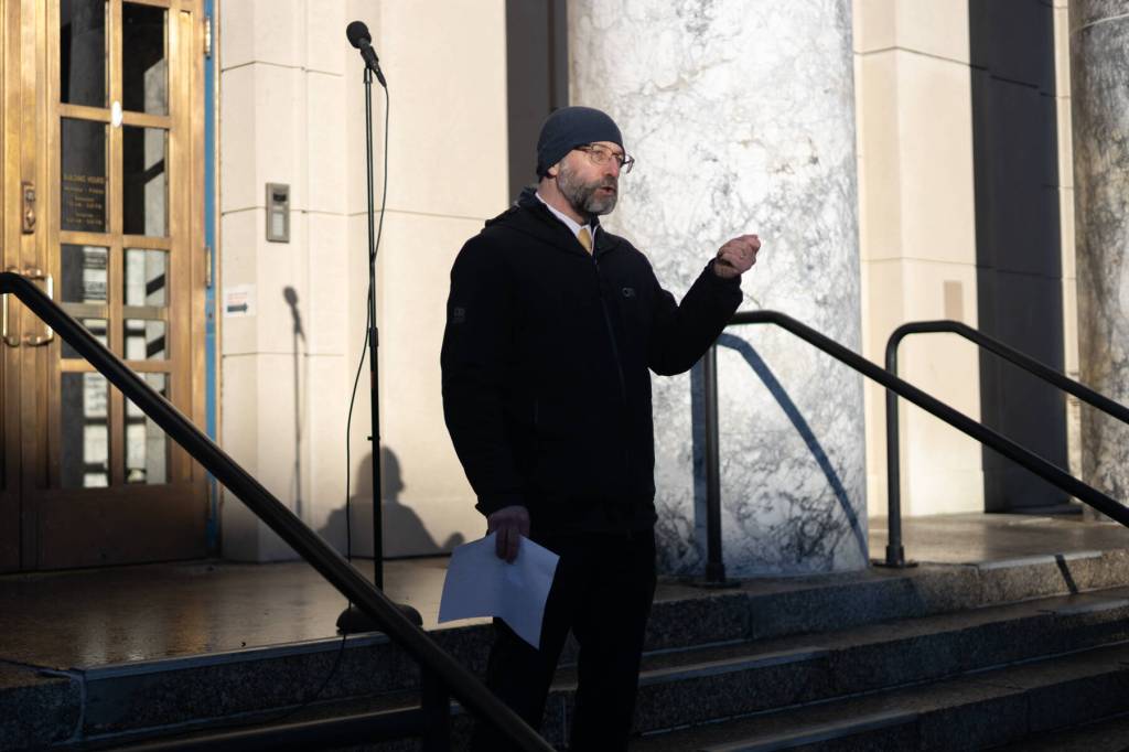 Sen. Jesse Kiehl, D-Juneau, speaks during a student-led protest against the LNG pipeline on Jan. 24, 2026. Dozens of Juneauites gathered outside the Alaska State Capitol building to participate in the demonstration. (Chloe Anderson / Juneau Empire)