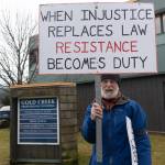Paul Desloover participates in a peaceful protest outside Senator Lisa Murkowskis Juneau office on Feb. 4, 2026. (Chloe Anderson/Juneau Empire)(Chloe Anderson/Juneau Empire)