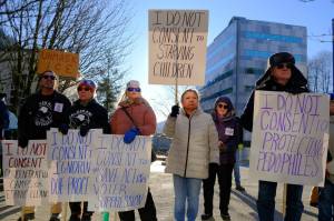Photo by Corinne Smith/Alaska Beacon
Demonstrators rally at the Alaska State Capitol to protest U.S. Sen. Dan Sullivan ahead of his annual address to the Legislature on Feb. 18, 2026.