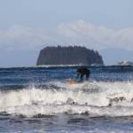 Surfer catches wave at Lena Cove. (Photo by Atticus Hempel/Juneau Empire)