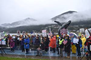 Protesters stand amidst the rain and fog at the No Tsars, No Kings protest on Oct. 18, 2025 at Overstreet Park. A third No Kings rally is planned in Juneau for Saturday, March 28. (Mari Kanagy/Juneau Empire file)