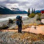 Bjorn Dihle stands in front of acid mine drainage at the abandoned Tulsequah Chief Mine, which flows into the Taku River. (Photo by Chris Miller/csmphotos.com)