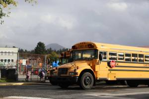 School buses park outside the playground of Xóots Elementary School in Sitka on Oct. 6, 2025 (Photo by Corinne Smith/Alaska Beacon)