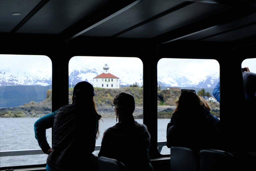 Passengers on the M/V Seawolf look out at the Eldred Rock Lighthouse on the day of the public opening on May 30, 2026. (Photo by Corinne Smith/Alaska Beacon)