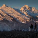 In this Jan. 8, 2018 photo, a couple walks along the Airport Dike Trail as the evening light shines on Mt. McGinnis, left, and Stroller White Mountain. (Michael Penn | Juneau Empire File)